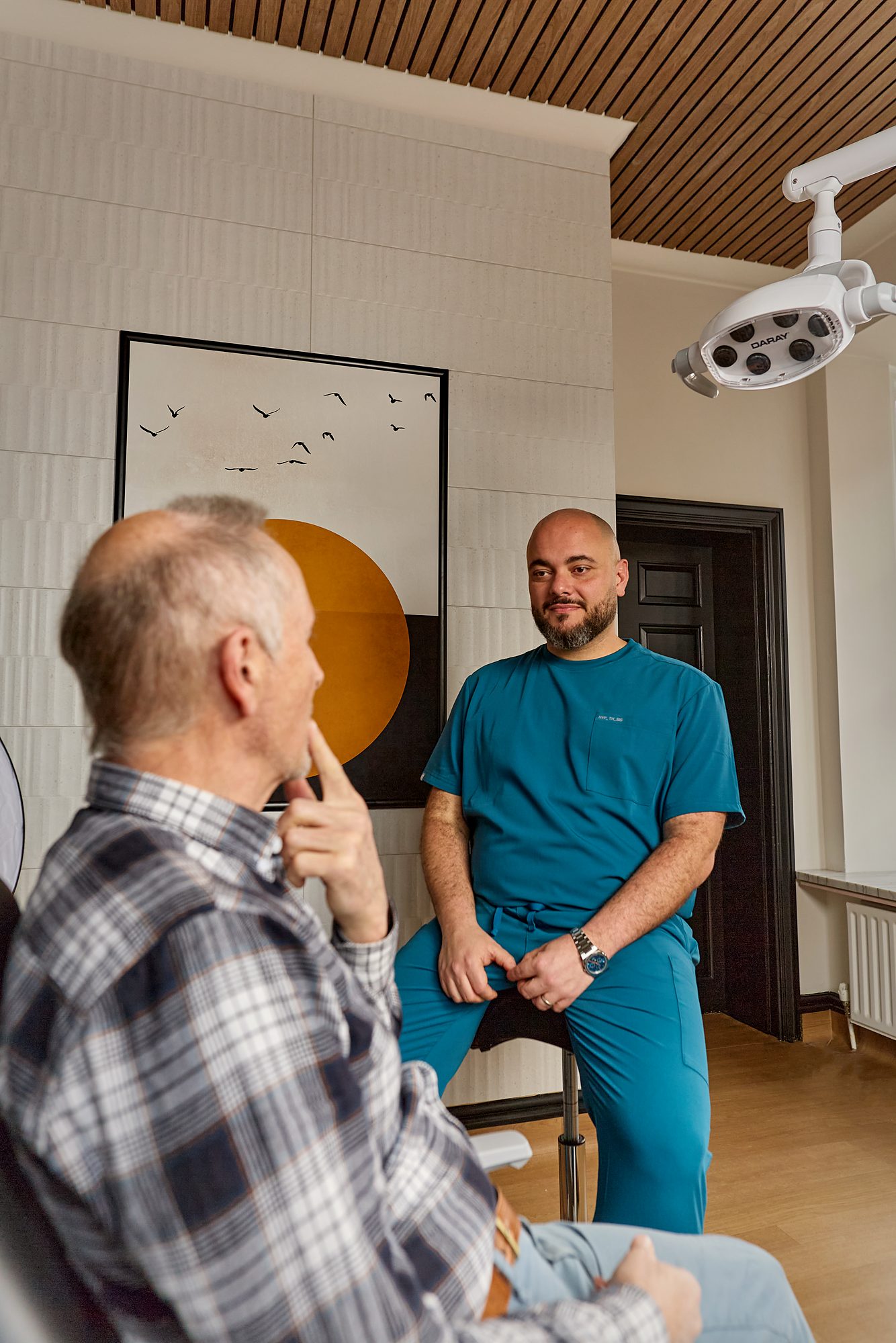 The second treatment room in use, white tile below the slatted timber ceiling