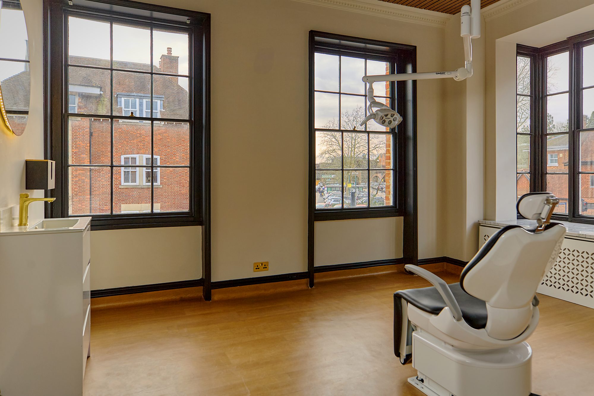 A treatment room as built, with sash windows on two sides and the chair in the corner